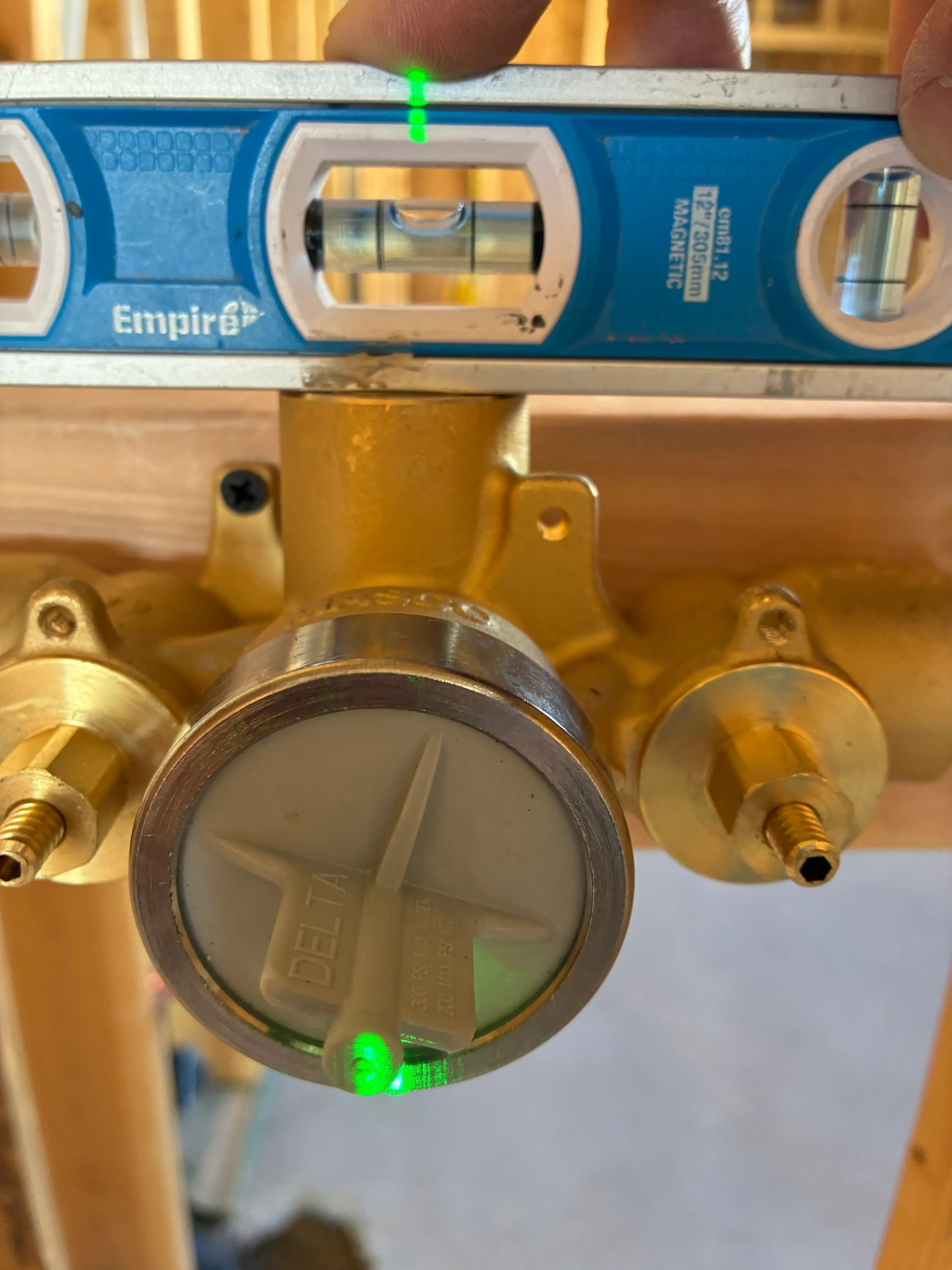 Brass pressure gauge with magnetic valve mounted on copper pipe with spirit level
